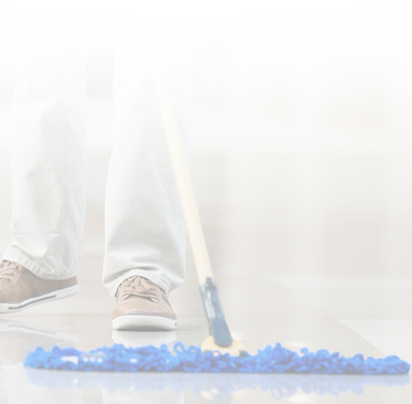 close up of khaki pants professional cleaner sweeping floor