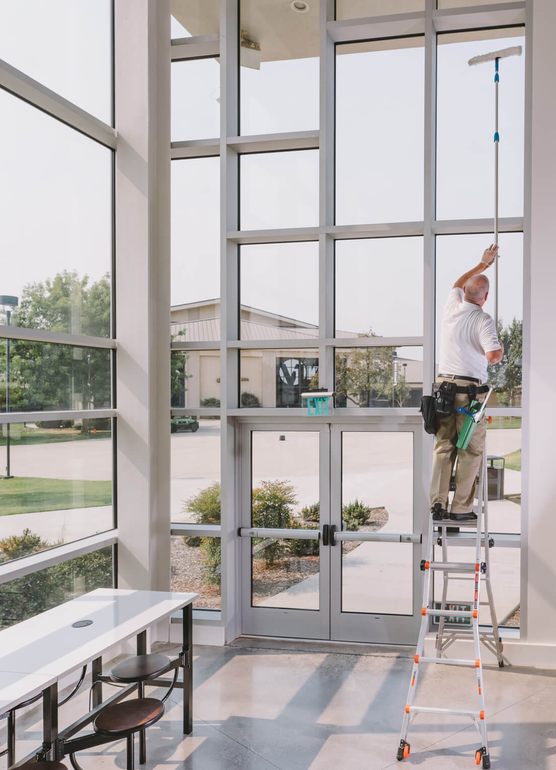 professional cleaning of entrance windows surrounding glass door
