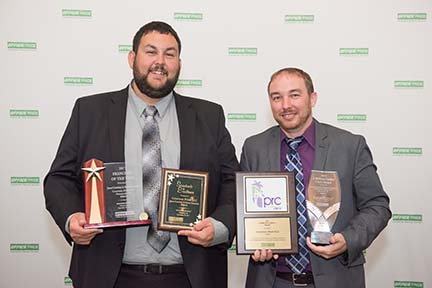 Office pride franchisee owners holding awards