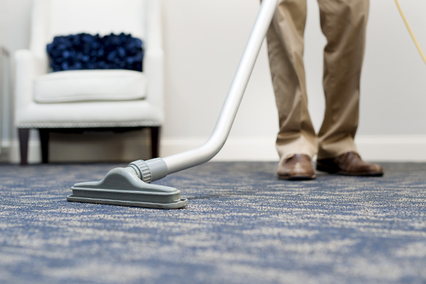 vacuum cleaning a carpet floor