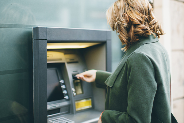 woman using ATM outside