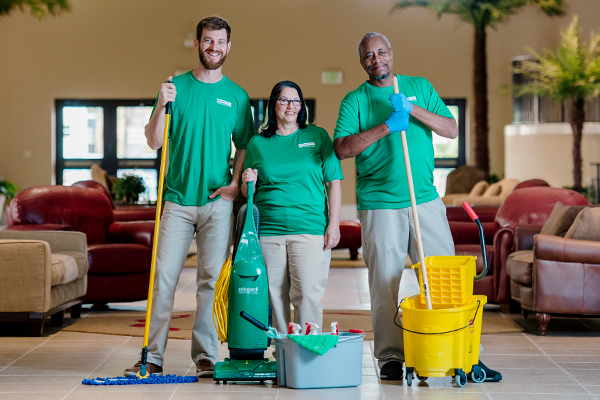 janitorial service team ready to clean commercial building interior