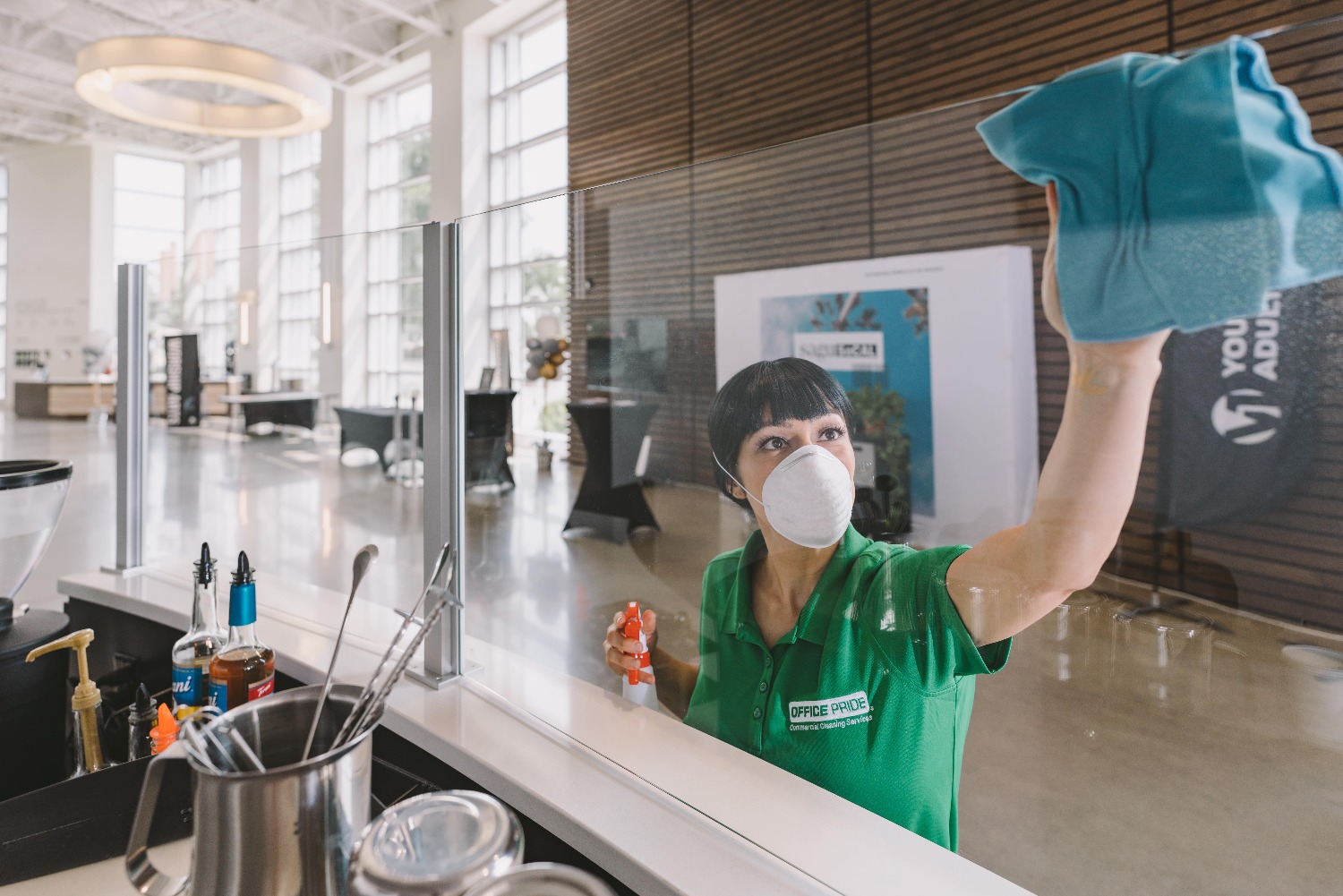 Professional commercial cleaner cleaning glass