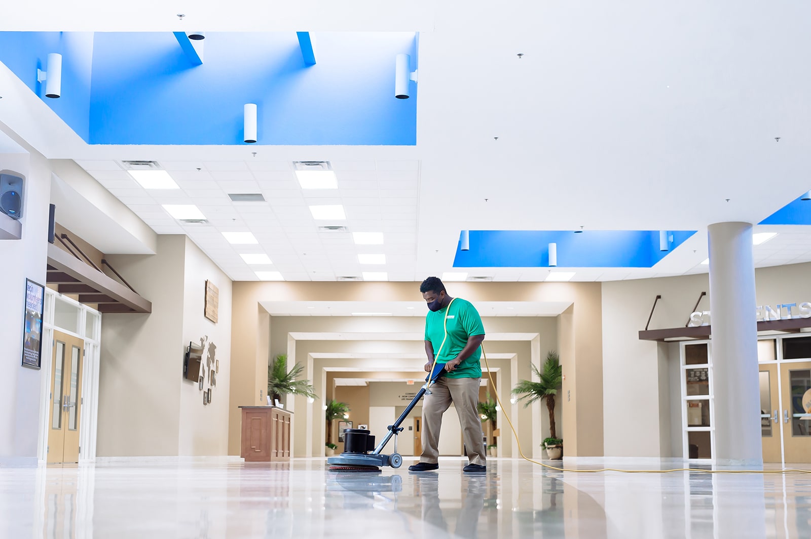 professional commercial cleaner buffing lobby floors